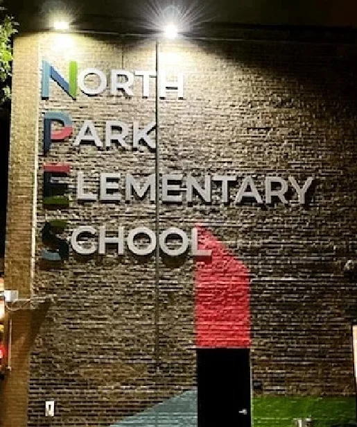 Dimensional letters on a brick school wall